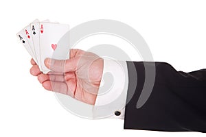 Man's hand with four aces
