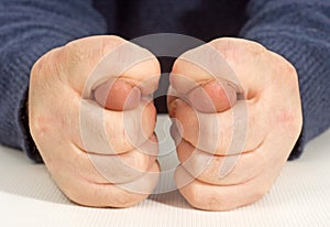 Man's hand gesture shows fig.