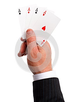 Man's hand holding aces