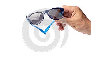 Man& x27;s hand holding blue sunglasses isolated on white background with clipping path.