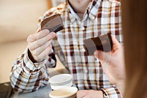 Man`s hand holding brownie cake