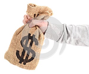 Man`s hand is holding burlap sack with dollar money bag