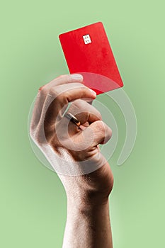 Man& x27;s hand holding credit card.