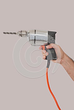 Man's hand holding a drill