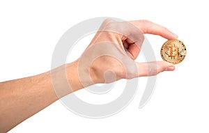 Man`s hand holding golden Bitcoin