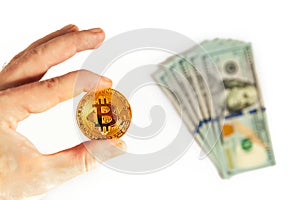 Man`s hand holding golden Bitcoin isolated on white background