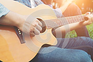 Man`s hand holding guitar chords, train all the time.