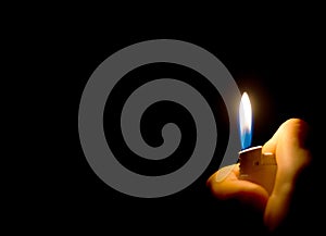 Man`s hand holding a lighter. .