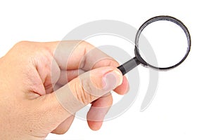 Man's hand holding magnifying glass, closeup