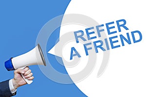 Man`s Hand Holding Megaphone With Speech Bubble REFER A FRIEND. Banner For Business, Announcement, Marketing And Advertising