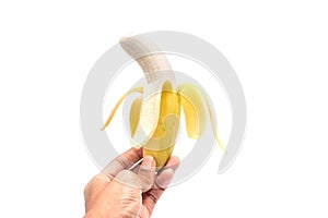 Man`s hand holding a pilled banana.