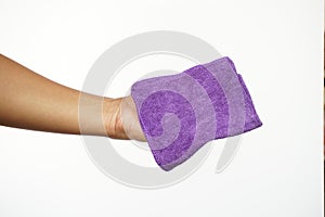 Man's hand holding a purple towel. White background