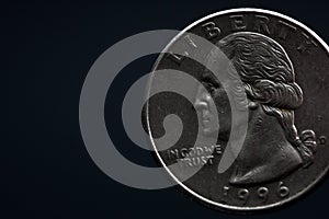 Man's hand holding a silver American coin, close-up of a quarter dollar coin isolated over black. Bag, dollars