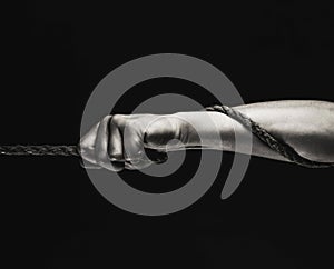 Man`s hand holding on to the rope. Hand holding a rope, climbing rope, strength and determination concept. Rope, cord