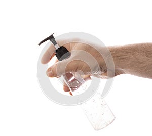 man& x27;s hand holds antiseptic gel from a transparent plastic bottle on a white background. concept of counteracting the virus