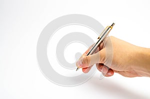 A man`s hand holds a pen on a white background. The man writes with a pen. The man puts a signature on the documents. The concept