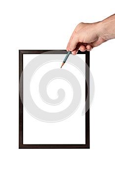 A man's hand holds a pencil. Wooden frame on a white background