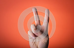 Man's hand isolated on orange red background