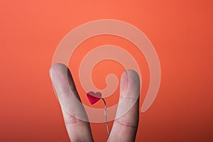 Man's hand isolated on orange red background