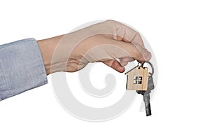 A man's hand isolated on a white background dropping a set of keys. real estate transaction. A man's hand holds the key to the