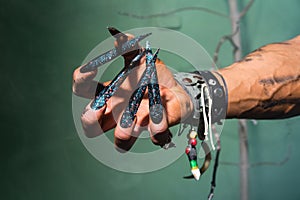 Man's hand with long nails out of a nightmare