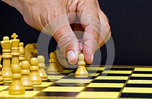 Man's hand making a chess move