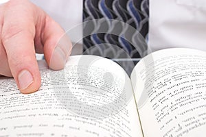 Man's Hand On Open Book