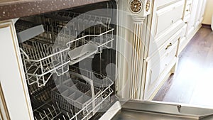 A man's hand opens and closes the built-in dishwasher door. Bosch