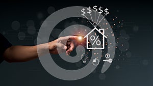 The man's hand pointing at a home icon on the versual screen. The concept of installment and reduction of Home Loan,