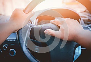 A man`s hand is pressed to the horn of a car to warn vehicles that are not complying with traffic laws, which could pose a danger