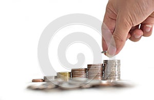 Man`s hand put money coins to stack of coins