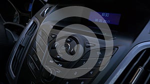 Man`s hand puts the disk into the car player. Button control for compact disk player in a car. Hand puts the disk into