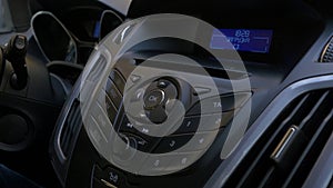 Man`s hand puts the disk into the car player. Button control for compact disk player in a car. Hand puts the disk into