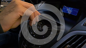 Man`s hand puts the disk into the car player. Button control for compact disk player in a car. Hand puts the disk into