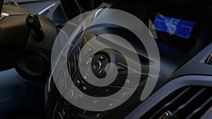 Man`s hand puts the disk into the car player. Button control for compact disk player in a car. Hand puts the disk into