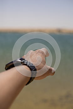 Man`s hand reaching out to sea POV shot
