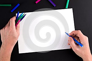 The man's hand, ready to draw a picture