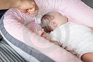 man\'s hand with ring combing a baby