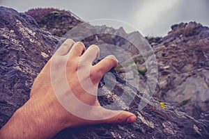 Man's hand on rock