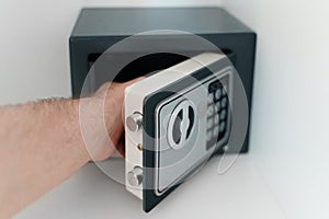 Man opening small safe
