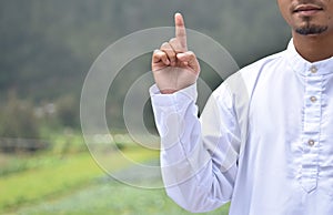 A man`s hand with a tauhid symbol on blur background