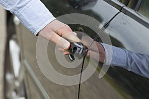 Man's Hand Unlocking Car Door.