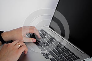 A man's hand uses a trackpad, Using a touchpad on a laptop photo