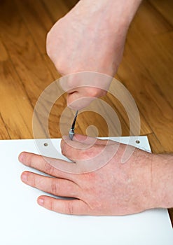 Man`s hand using screwdriver.