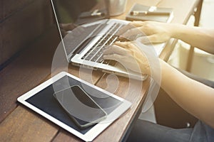 man's hand using smartphone with digital tablet