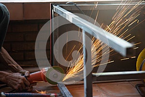 A man`s hand is using a steel cutter to make a spark table structure