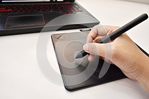 Man`s hand using wireless pen mouse for drawing