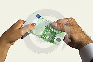 A man`s hand and a woman`s hand hold a one hundred euro bill.