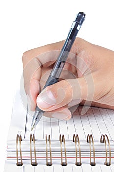 Man's hand writing on a book