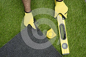 Man`s hands with the artificial grass
